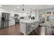 Bright kitchen featuring white cabinets, stainless appliances, breakfast bar, and wood flooring at 4213 Schooner Ne Ct, Roswell, GA 30075