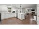 Open concept kitchen features stainless appliances, white cabinets, and view to the Gathering room at 4213 Schooner Ne Ct, Roswell, GA 30075