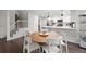 Kitchen and breakfast nook features white cabinets, stainless appliances, and eat-in table at 4213 Schooner Ne Ct, Roswell, GA 30075