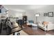 Cozy living room area with a comfortable seating arrangement and hardwood floors at 4213 Schooner Ne Ct, Roswell, GA 30075