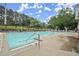 Community swimming pool with sun loungers and picnic area, set against a backdrop of mature trees at 4213 Schooner Ne Ct, Roswell, GA 30075