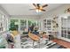 Bright sunroom features floor to ceiling windows, tiled floor, and cozy seating with an exercise bike at 4213 Schooner Ne Ct, Roswell, GA 30075