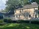 View of backyard featuring wood deck, manicured lawn, mature trees, and neutral-toned siding at 7260 Dunhill Ter, Atlanta, GA 30328