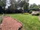 Expansive backyard with lush green grass, mature trees, and a charming garden area, perfect for outdoor enjoyment at 7260 Dunhill Ter, Atlanta, GA 30328