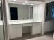 Bathroom vanity features a large mirror, sink with chrome faucet, and ample storage in white cabinets at 7260 Dunhill Ter, Atlanta, GA 30328