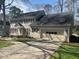 Traditional two-story home featuring a welcoming porch, attached two car garage, and well-maintained lawn at 7260 Dunhill Ter, Atlanta, GA 30328