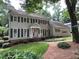 Charming two-story house with a manicured lawn, complemented by flowering bushes at 7260 Dunhill Ter, Atlanta, GA 30328