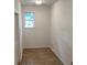 Hallway with tiled floor, natural light, and white walls at 7260 Dunhill Ter, Atlanta, GA 30328