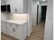 Updated kitchen boasts bright white cabinets, modern appliances, and stylish countertop with complementary backsplash at 7260 Dunhill Ter, Atlanta, GA 30328