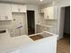 Bright kitchen boasts white cabinets, counters, and modern design, creating a clean and inviting space at 7260 Dunhill Ter, Atlanta, GA 30328
