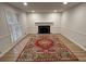 Bright living room with a fireplace, complemented by a colorful rug on wood flooring at 7260 Dunhill Ter, Atlanta, GA 30328