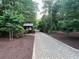 Paver path winds through a wooded area with lush trees and landscaping in the community at 7260 Dunhill Ter, Atlanta, GA 30328