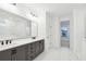 Modern bathroom with dual vanity, gray cabinets, and a large mirror at 2340 Ellis Mountain Dr, Marietta, GA 30064