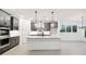 Modern kitchen boasts gray cabinets, stainless steel appliances, an island, and stylish pendant lighting at 2340 Ellis Mountain Dr, Marietta, GA 30064