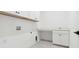 Bright laundry room featuring white cabinets, gray tile flooring, and plenty of counter space at 2340 Ellis Mountain Dr, Marietta, GA 30064
