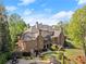 Lush backyard with a patio, custom pool, mature trees, and meticulously kept landscaping at 3562 Langley Oaks Se Ct, Marietta, GA 30067