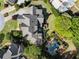 Aerial view of the home with meticulously landscaped grounds, an inviting pool, and outdoor entertaining areas at 3562 Langley Oaks Se Ct, Marietta, GA 30067