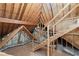 Spacious unfinished attic with wooden beams and stairs at 3562 Langley Oaks Se Ct, Marietta, GA 30067