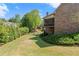 Manicured backyard featuring an upper level screened porch on a brick home at 3562 Langley Oaks Se Ct, Marietta, GA 30067