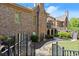 Stunning backyard showcasing the home's brick exterior, arched patio, and mature landscaping at 3562 Langley Oaks Se Ct, Marietta, GA 30067