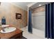 The bathroom has dual sinks, tile flooring, tiled walls, and a bathtub with a shower at 3562 Langley Oaks Se Ct, Marietta, GA 30067