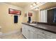 Traditional bathroom with a white vanity, dark countertop, framed mirror, and neutral walls at 3562 Langley Oaks Se Ct, Marietta, GA 30067