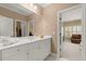 Bright bathroom vanity with white cabinets and a view into the bedroom at 3562 Langley Oaks Se Ct, Marietta, GA 30067