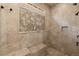 Large tiled shower with a built-in bench and decorative tile accent at 3562 Langley Oaks Se Ct, Marietta, GA 30067