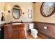 Charming bathroom with a wooden vanity, round window, and stylish wall sconces at 3562 Langley Oaks Se Ct, Marietta, GA 30067