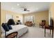 Large bedroom with a loveseat, desk, ceiling fan, and a window providing natural light at 3562 Langley Oaks Se Ct, Marietta, GA 30067
