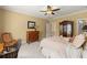 Bedroom featuring a dresser, desk, ceiling fan, and ample natural light at 3562 Langley Oaks Se Ct, Marietta, GA 30067