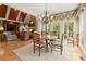 Sunlit breakfast nook with large windows offering scenic views, adjoined by a cozy living room at 3562 Langley Oaks Se Ct, Marietta, GA 30067