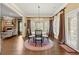 Open dining room features hardwood flooring, decorative lighting, and many windows at 3562 Langley Oaks Se Ct, Marietta, GA 30067