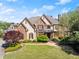 Stunning two-story brick home featuring a manicured lawn, lush landscaping, and a welcoming front entrance at 3562 Langley Oaks Se Ct, Marietta, GA 30067