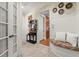 Inviting foyer with tile floors, bench seating and decorative hat rack in a custom home at 3562 Langley Oaks Se Ct, Marietta, GA 30067