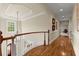 Hallway with hardwood floors, decorative painting and trey ceiling leads to the bedrooms at 3562 Langley Oaks Se Ct, Marietta, GA 30067
