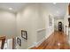 Well-lit hallway with hardwood floors and detailed molding leads to the upper level of the home at 3562 Langley Oaks Se Ct, Marietta, GA 30067