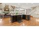 Open concept kitchen with an island, stone fireplace, stainless appliances, and natural light at 3562 Langley Oaks Se Ct, Marietta, GA 30067