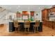 Chef's kitchen with an island, wooden cabinetry, modern stainless appliances, and barstool seating at 3562 Langley Oaks Se Ct, Marietta, GA 30067