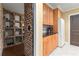 View of a custom wine cellar next to the kitchen with granite countertops and wooden cabinets at 3562 Langley Oaks Se Ct, Marietta, GA 30067