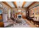 Cozy living room with a fireplace, wood beams, and comfortable seating at 3562 Langley Oaks Se Ct, Marietta, GA 30067
