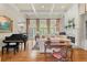 Elegant living room with coffered ceilings, fireplace, grand piano, and French doors at 3562 Langley Oaks Se Ct, Marietta, GA 30067