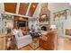 Inviting living room features a stone fireplace, wood-paneled ceiling, and custom built-ins at 3562 Langley Oaks Se Ct, Marietta, GA 30067