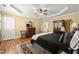 Comfortable main bedroom with tray ceilings, ceiling fan, and hardwood flooring at 3562 Langley Oaks Se Ct, Marietta, GA 30067