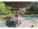Enjoy resort-style living with this pool, lush landscaping, and lounge seating under a shady umbrella at 3562 Langley Oaks Se Ct, Marietta, GA 30067