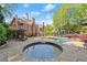 Backyard oasis featuring a sparkling pool and spa, surrounded by lush landscaping and patio area at 3562 Langley Oaks Se Ct, Marietta, GA 30067