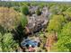 Spacious home with manicured lawns, beautiful landscaping, a pool, and an outdoor entertainment area at 3562 Langley Oaks Se Ct, Marietta, GA 30067