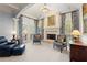 Cozy sitting area with a fireplace, blue armchairs, and elegant window treatments at 3562 Langley Oaks Se Ct, Marietta, GA 30067