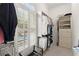 Walk-in closet with custom shelving, storage options and a view of the pool through shuttered windows at 3562 Langley Oaks Se Ct, Marietta, GA 30067