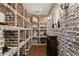 Unique brick wine cellar with custom shelving, wooden crates, and recessed lighting at 3562 Langley Oaks Se Ct, Marietta, GA 30067